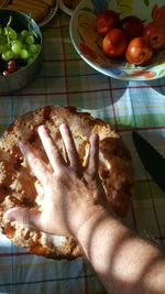High angle view of hand holding fruits in plate