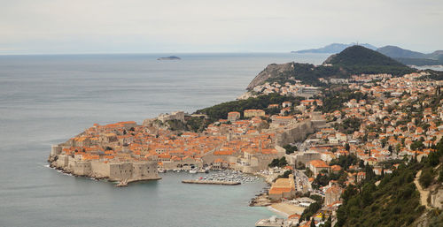 High angle view of sea and buildings against sky