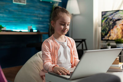 Young woman using laptop at home