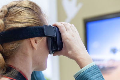 Mid adult woman using virtual reality at home