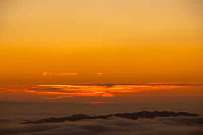 Scenic view of sea against orange sky