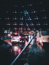 Illuminated city street during rainy season at night