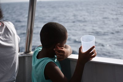 Rear view of woman drinking glass