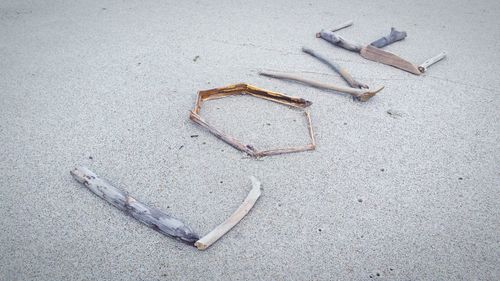 High angle view of love text on sand at beach