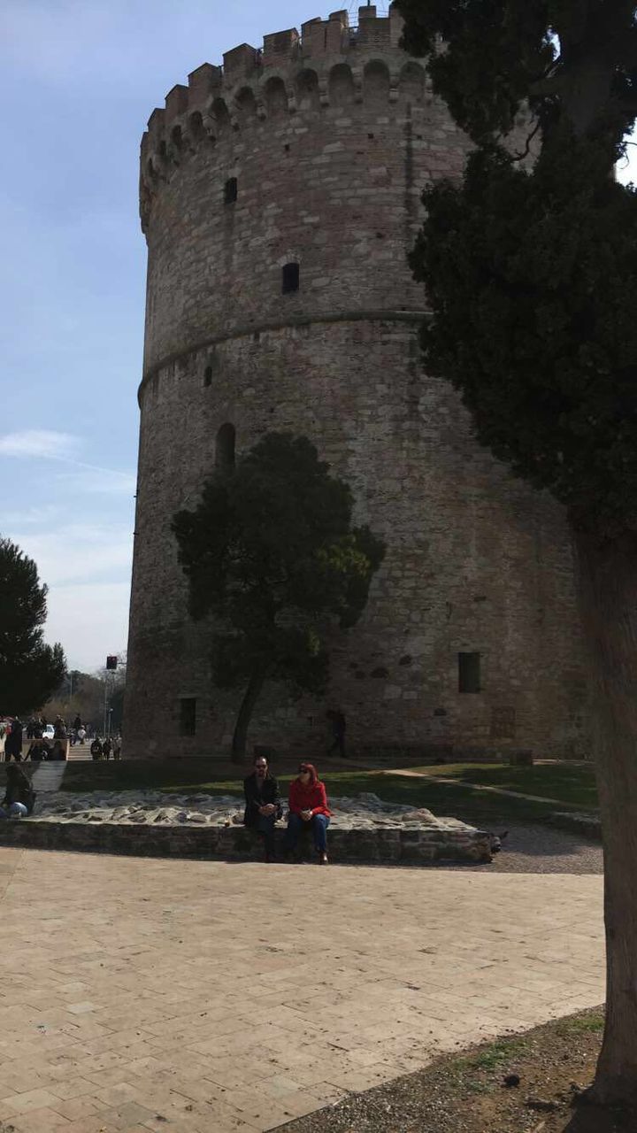 real people, architecture, built structure, history, building exterior, men, old ruin, lifestyles, women, leisure activity, travel destinations, two people, day, tourism, outdoors, tree, ancient, sky, ancient civilization, togetherness, nature, adult, people