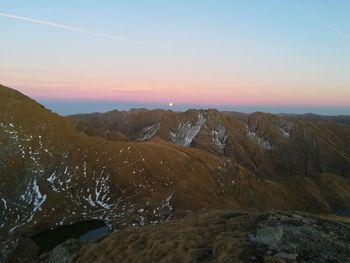 Scenic view of snowcapped mountains against sky during sunset