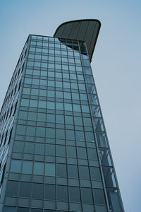 Low angle view of modern glass building against sky