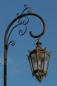 Low angle view of lamp against blue sky