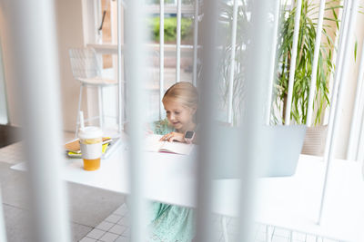 High angle view of girl studying at home