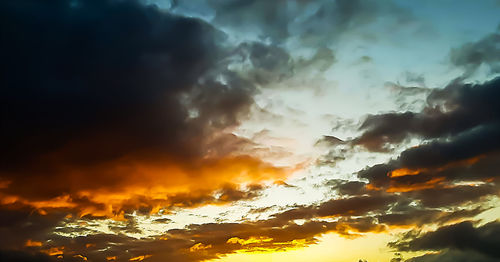 Low angle view of dramatic sky during sunset