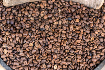 Top view of dark roast coffee beans background.