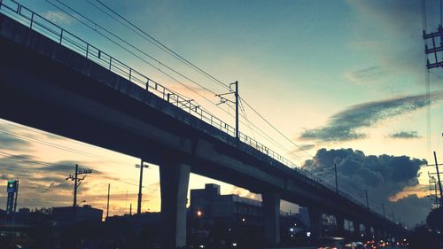 Low angle view of suspension bridge against sky