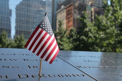 Close up of an american flag left on the 9/11 memorial in nyc.