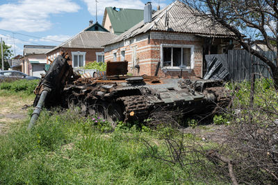 A burnt russian tank near a residential building. war in ukraine 2022. russian missiles in kharkiv