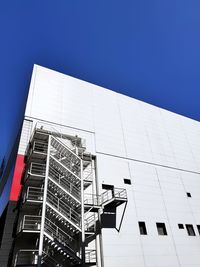 Low angle view of modern building against clear blue sky