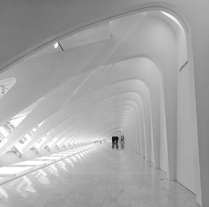 Rear view of people walking in illuminated building