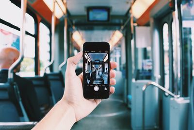 Cropped image of person holding smart phone