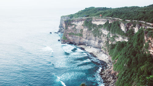 Scenic view of sea by cliff