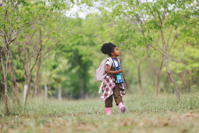 Full length of cute baby girl on field