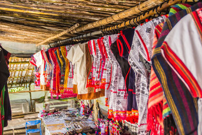 Multi colored flags hanging at market stall