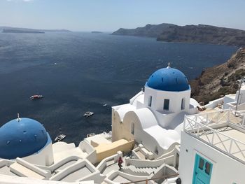 Panoramic view of sea and buildings against sky