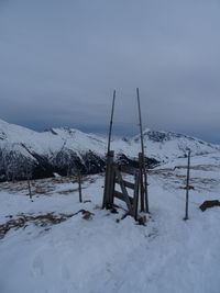 Scenic view of snow covered field against sky