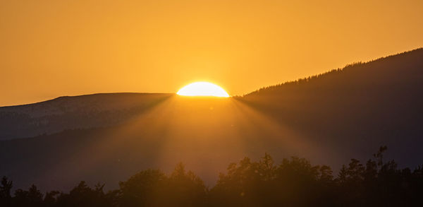 Dramatic silhouette sunset over lavanttaler alps in styria. styrian alps covered with snow 