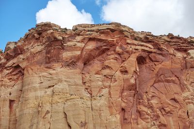 Low angle view of rock formations against sky