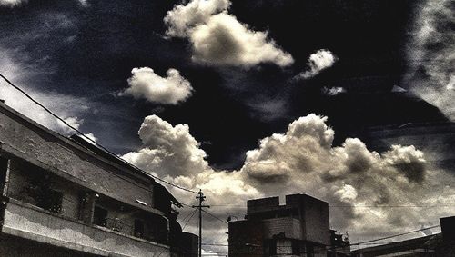 Low angle view of building against cloudy sky