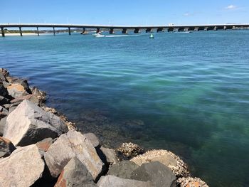 Bridge over sea against sky