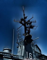 Low angle view of crane against blue sky