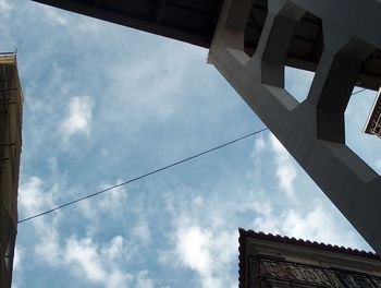 Low angle view of building against cloudy sky