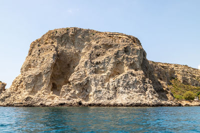 Low angle view of rock formation against clear sky