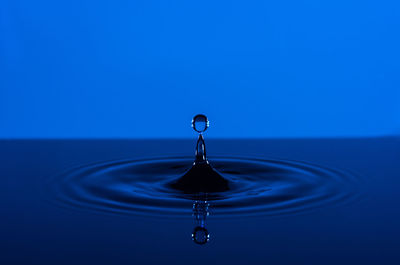 Close-up of water splashing against blue sky