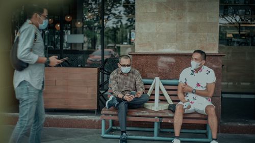 People sitting on table at sidewalk cafe