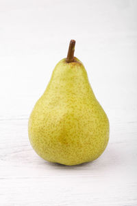 Close-up of fruit on table against white background