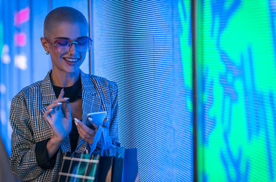 Portrait of smiling young man using smart phone