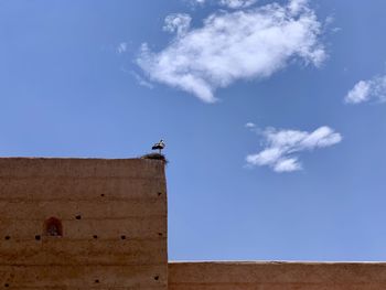 Low angle view of a building against blue sky in marrakesh