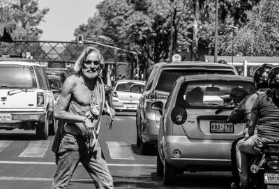 Portrait of smiling young woman standing on road