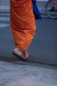 Low section of woman walking on floor