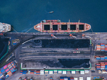 Russia, primorsky krai, vladivostok, aerial view of industrial ship moored in coal loading dock