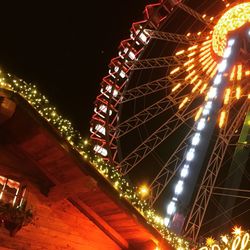 Low angle view of illuminated ferris wheel at night