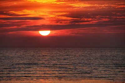 Scenic view of sea against romantic sky at sunset