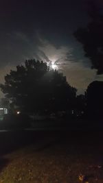 Silhouette trees against sky at night