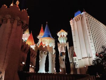 Low angle view of statue in city at night