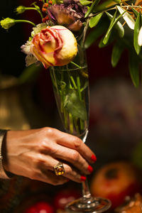 Close-up of hand holding rose bouquet