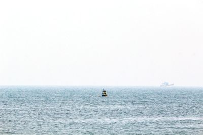 Person kayaking in sea