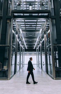 Rear view of man walking in building