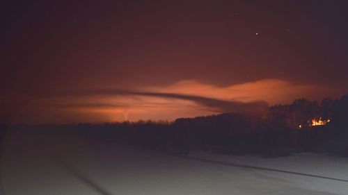 Scenic view of landscape against sky at night