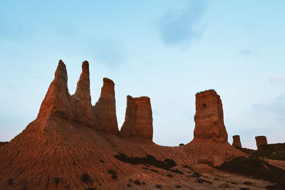 Rock formations on landscape against sky